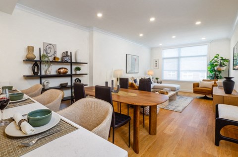 a living room and dining room with a table and chairs