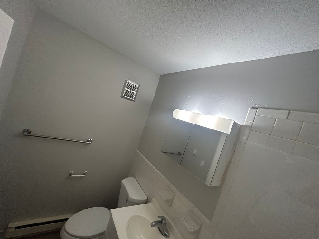 an empty bathroom with a toilet and a sink