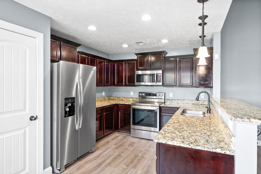 a kitchen with stainless steel appliances and granite counter tops
