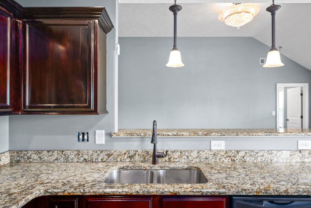 a kitchen with granite counter tops and a sink