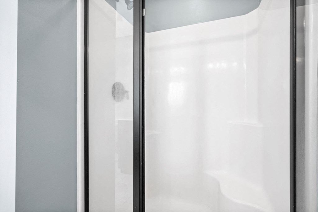 a frosted glass shower door in a bathroom