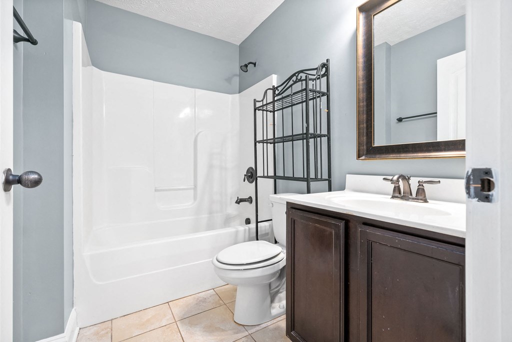 a bathroom with a toilet and a sink and a shower