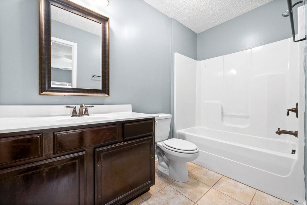a bathroom with a toilet sink and shower