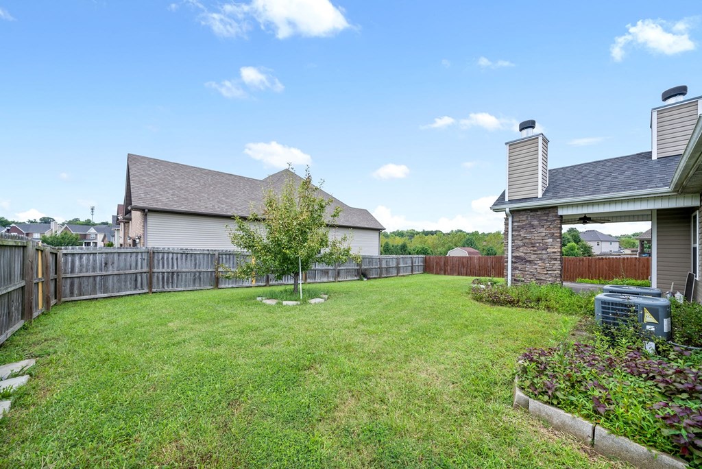 the backyard of a house with a yard and a fence