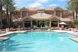 a large swimming pool in front of a resort building