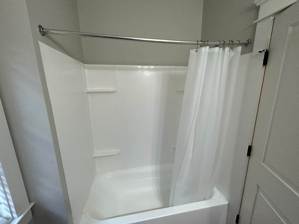 a small bathroom with a shower and a shower curtain