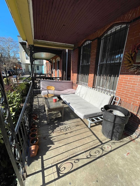 a patio with a couch and a table on a balcony