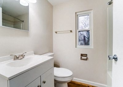 a bathroom with a sink toilet and a mirror