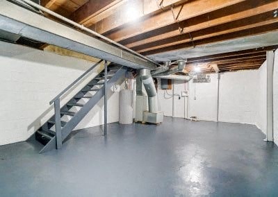 the inside of a garage with a metal staircase
