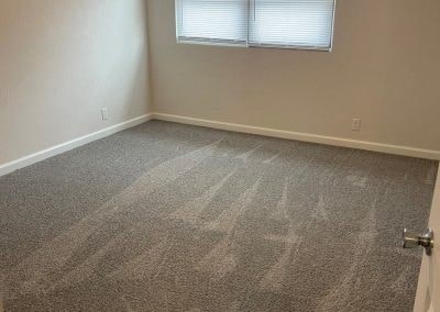 a room with a carpeted floor and a window