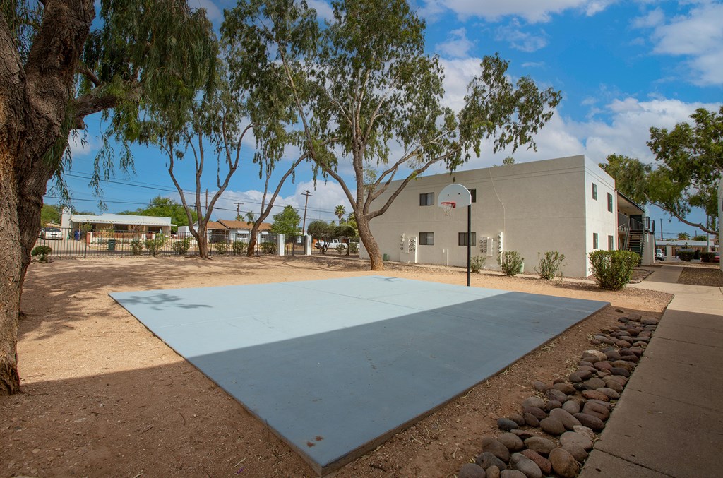 a blue basketball court in front of a building