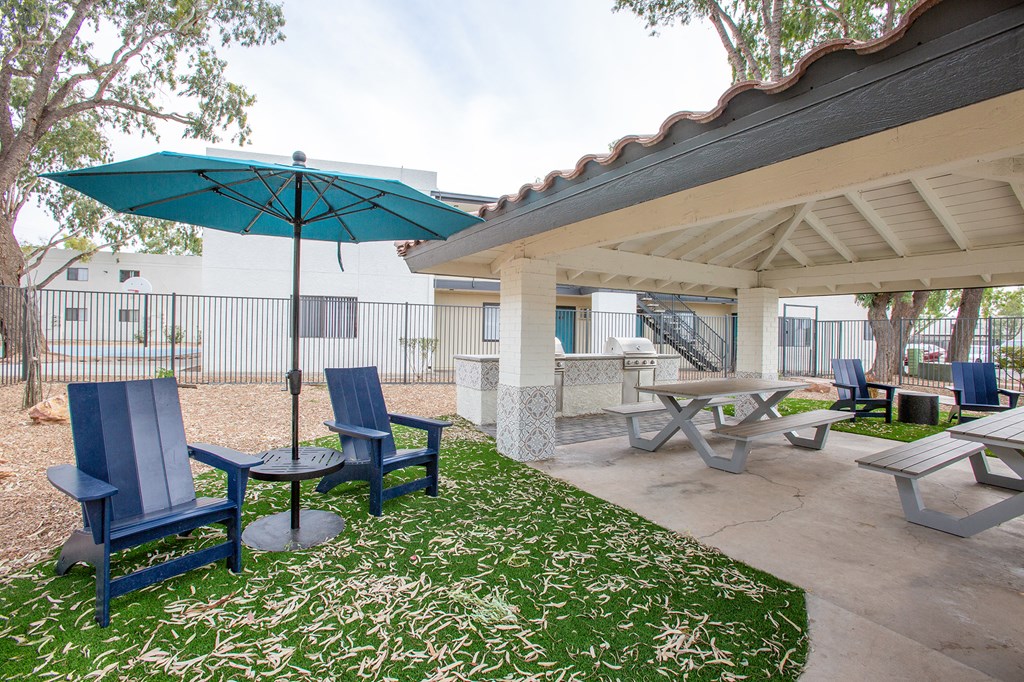 a covered patio with tables and chairs and umbrellas