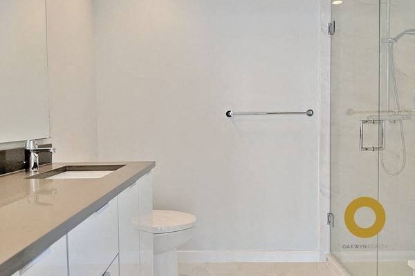 a bathroom with a toilet and a sink and a shower