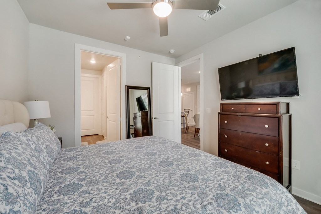 a bedroom with a large bed and a tv