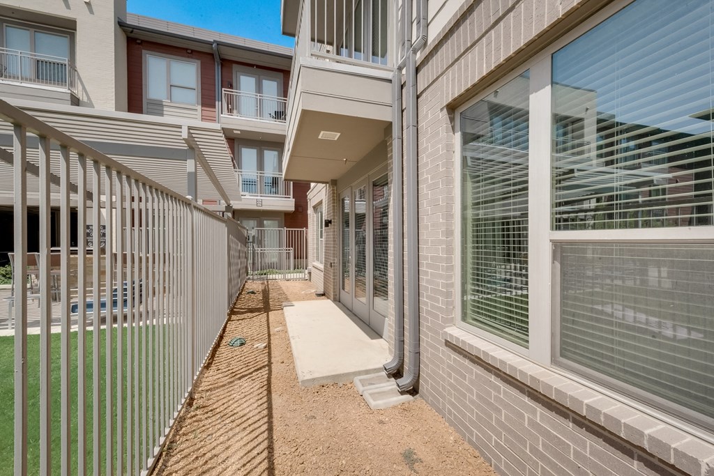 the preserve at ballantyne commons apartments exterior walkway with white fence and windows