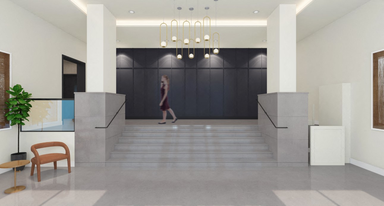 A woman is walking down a hallway with a plant on the left and a bench on the right.