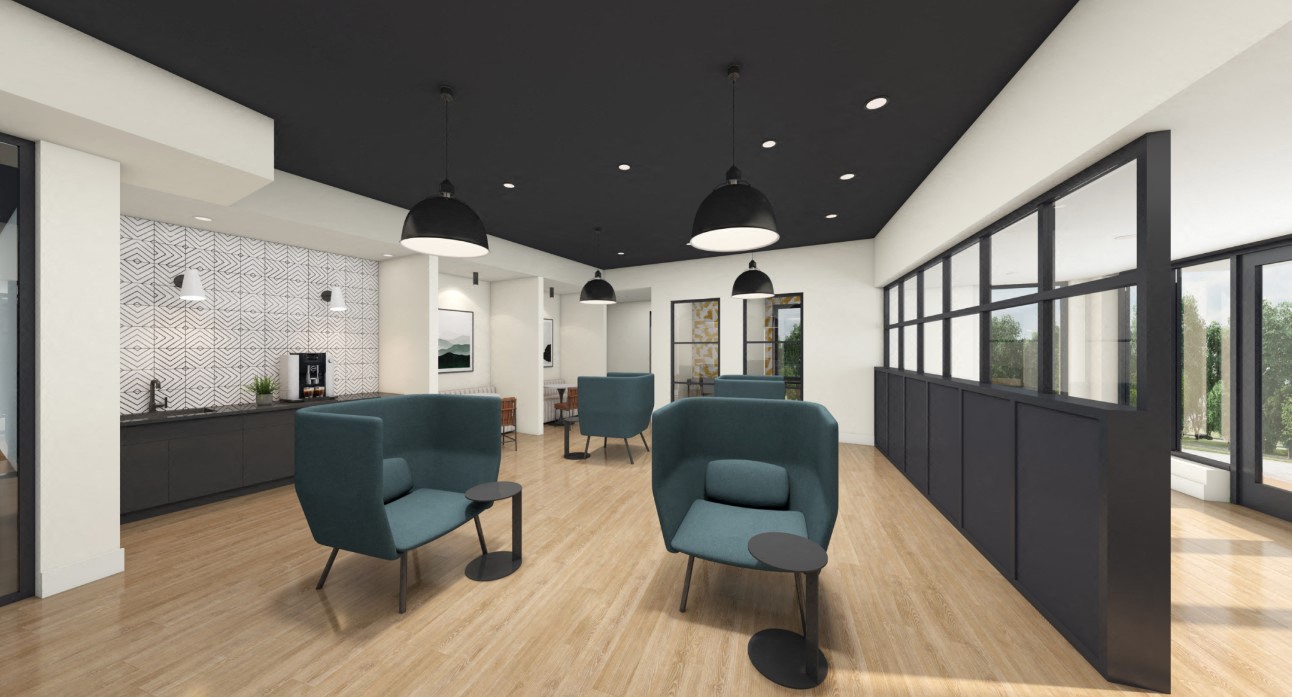 A modern waiting room with green chairs and a wooden floor.
