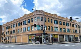 a large brick building on the corner of a street