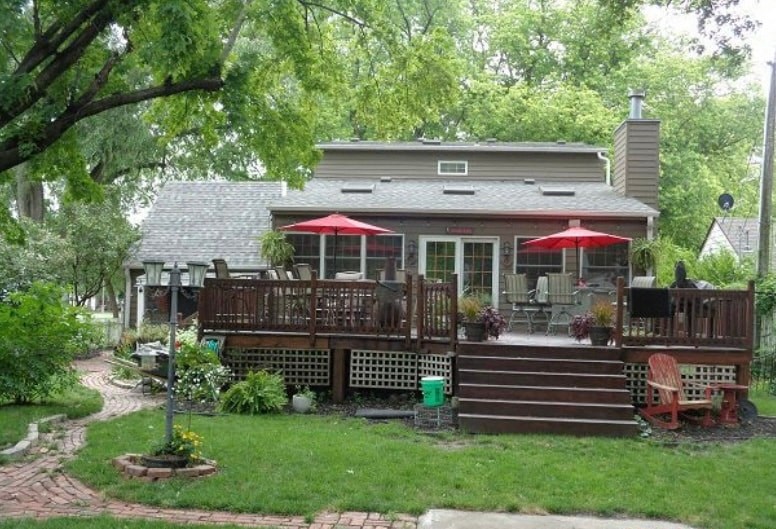a house with a deck and a patio with umbrellas