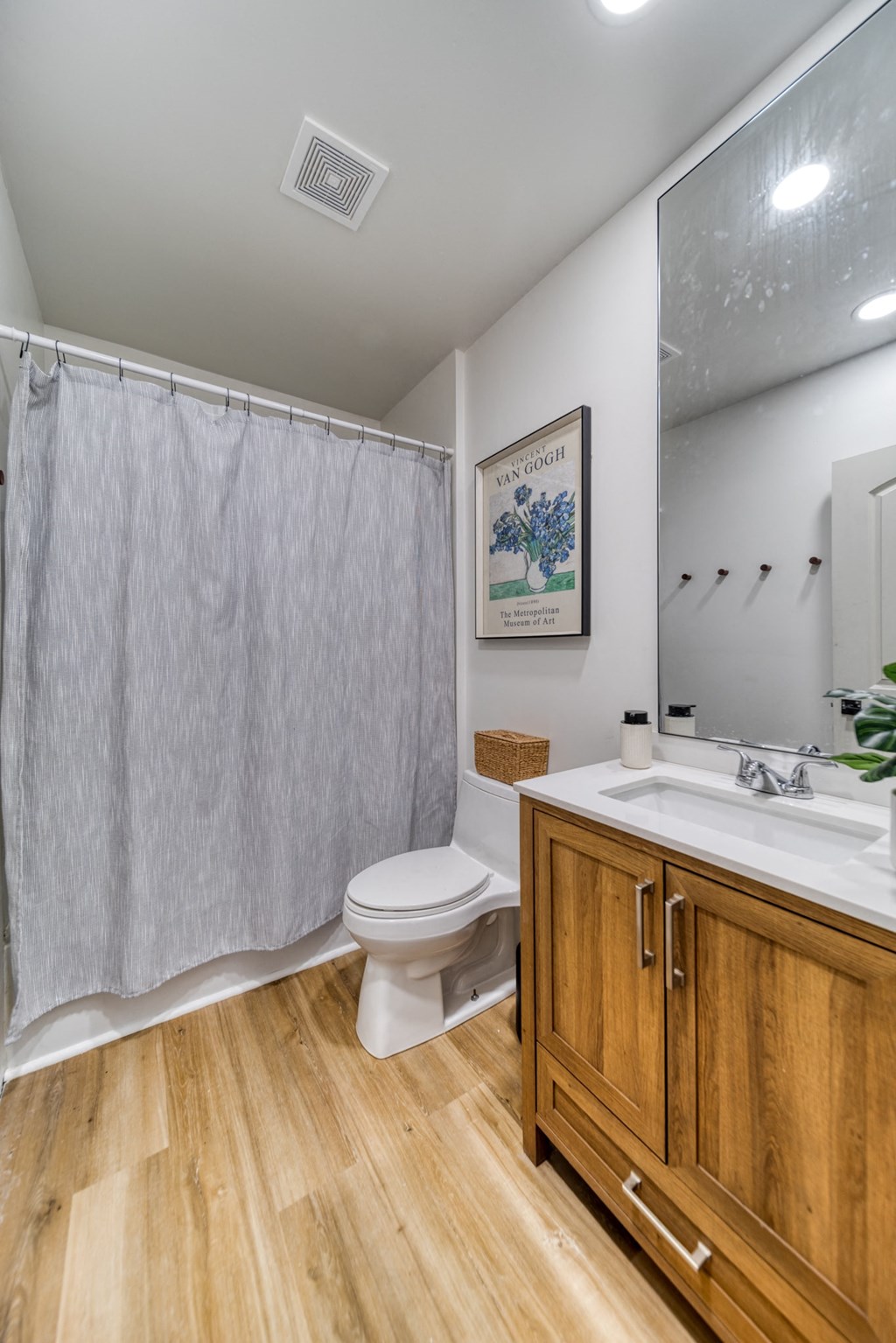 a bathroom with a toilet and a sink and a shower