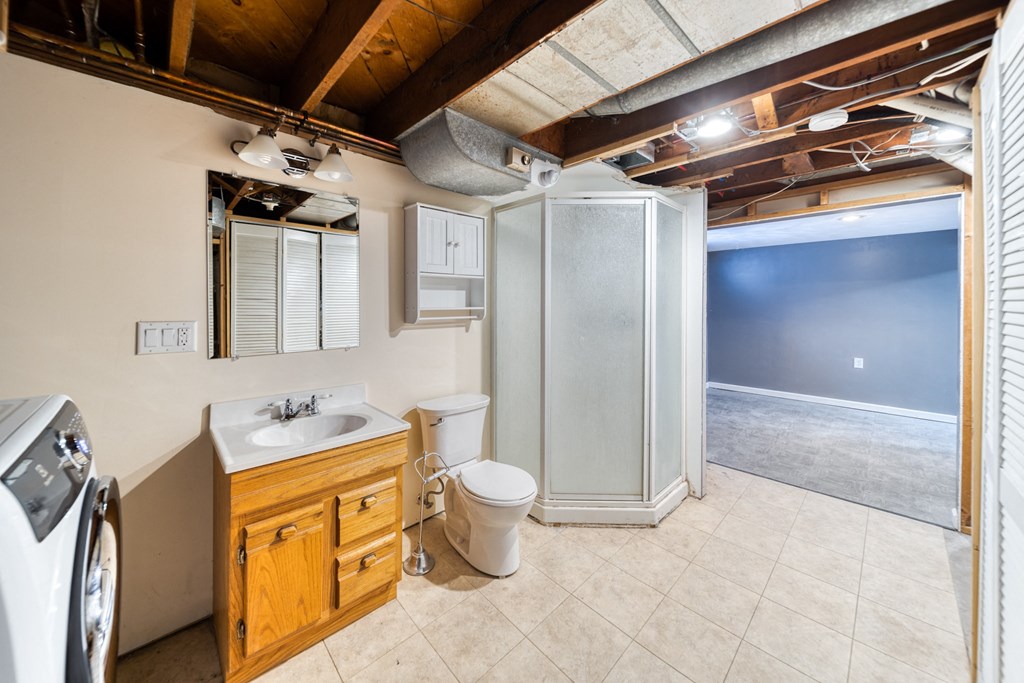 a bathroom with a sink toilet and a shower