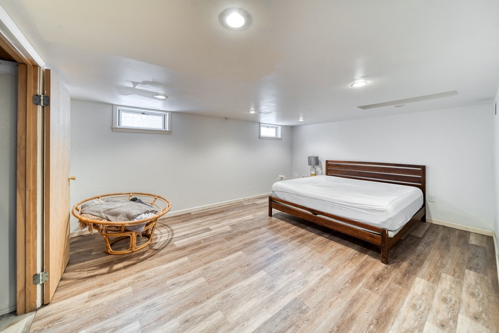 a bedroom with a bed and a chair and a door