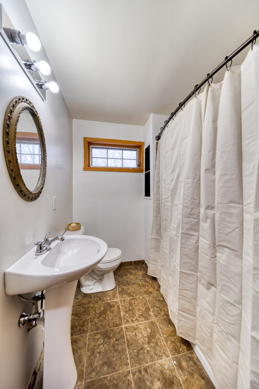a bathroom with a shower and a sink and a toilet