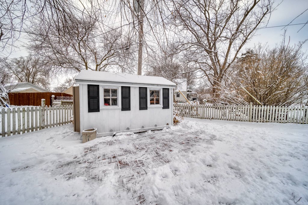 a tiny house in a yard covered in snow