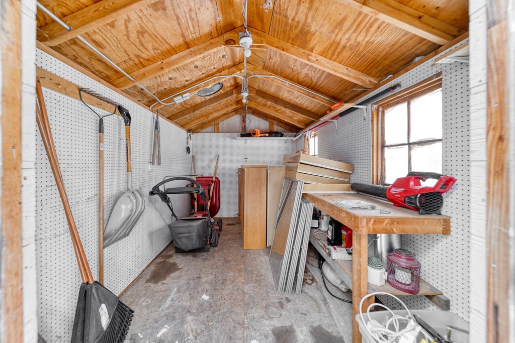a small shed with a table and tools in it