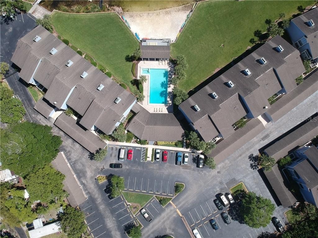 an overhead view of a neighborhood of houses and a swimming pool