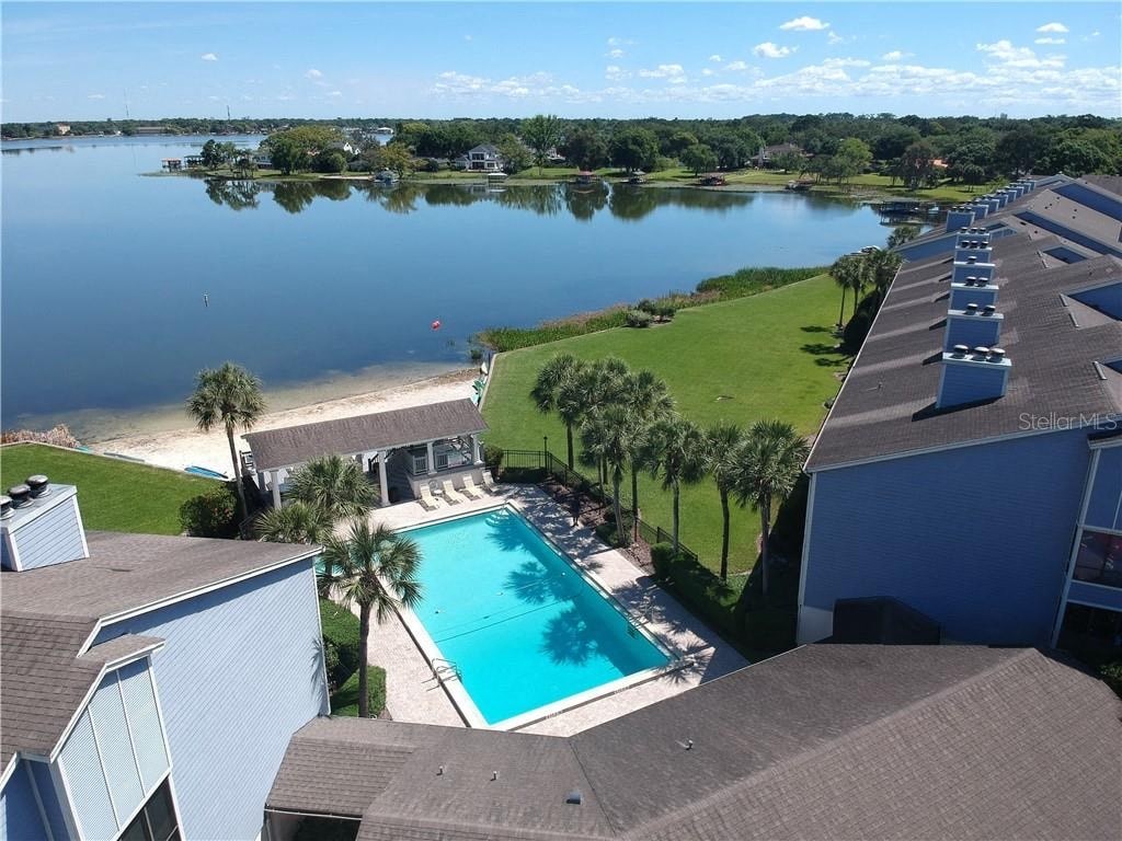 a view of the pool and a body of water from a house