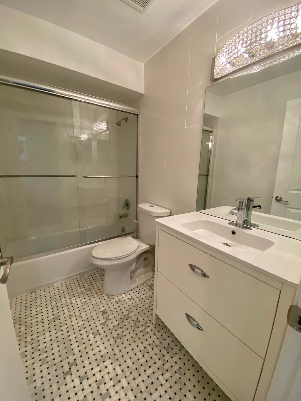a bathroom with a toilet and a sink and a shower
