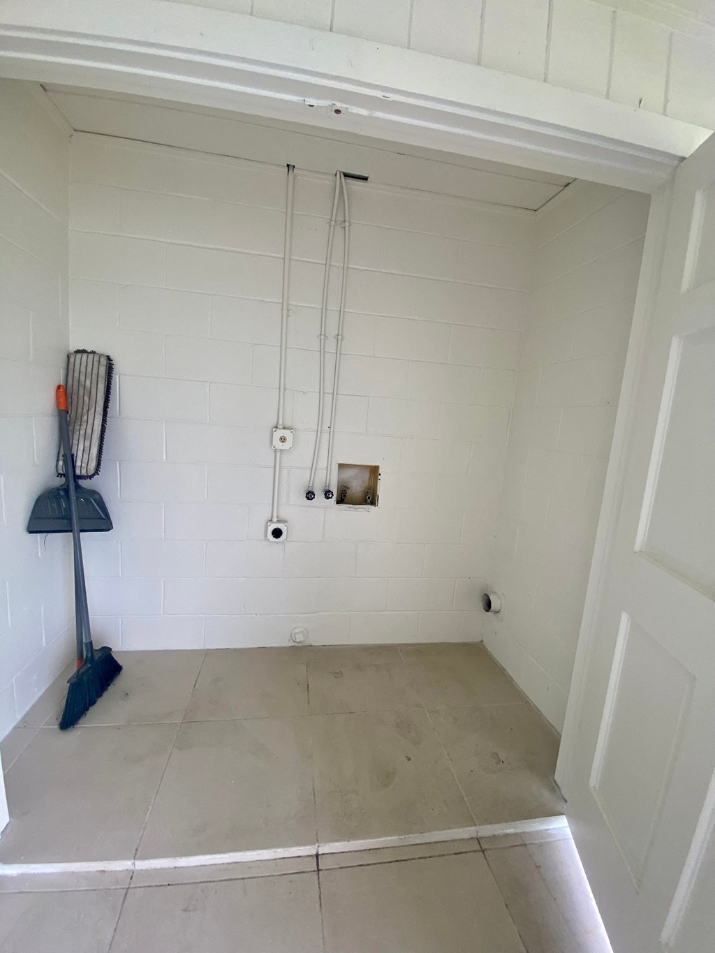 a room with a broom and a mop in it