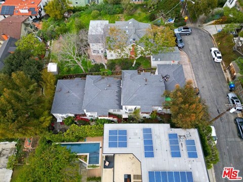 an aerial view of a house with solar panels on the roof