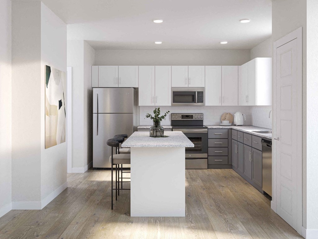 a kitchen with a white island and stainless steel appliances