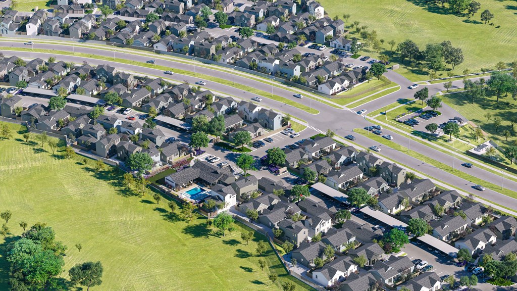 an aerial view of a suburb of a city with cars on the road