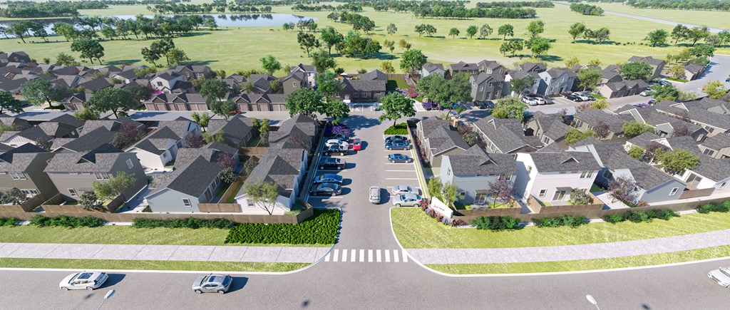 an aerial view of a neighborhood of houses with cars parked