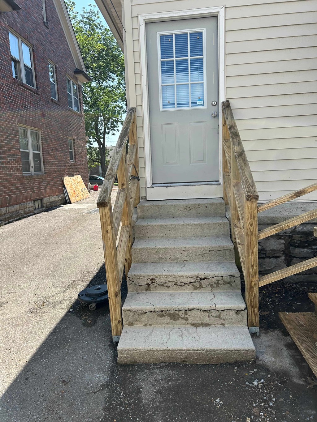 a set of stairs in front of a house with a white door