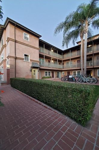 the courtyard of an apartment building with bicycles parked outside