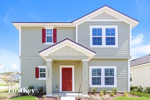 a beige house with a red door
