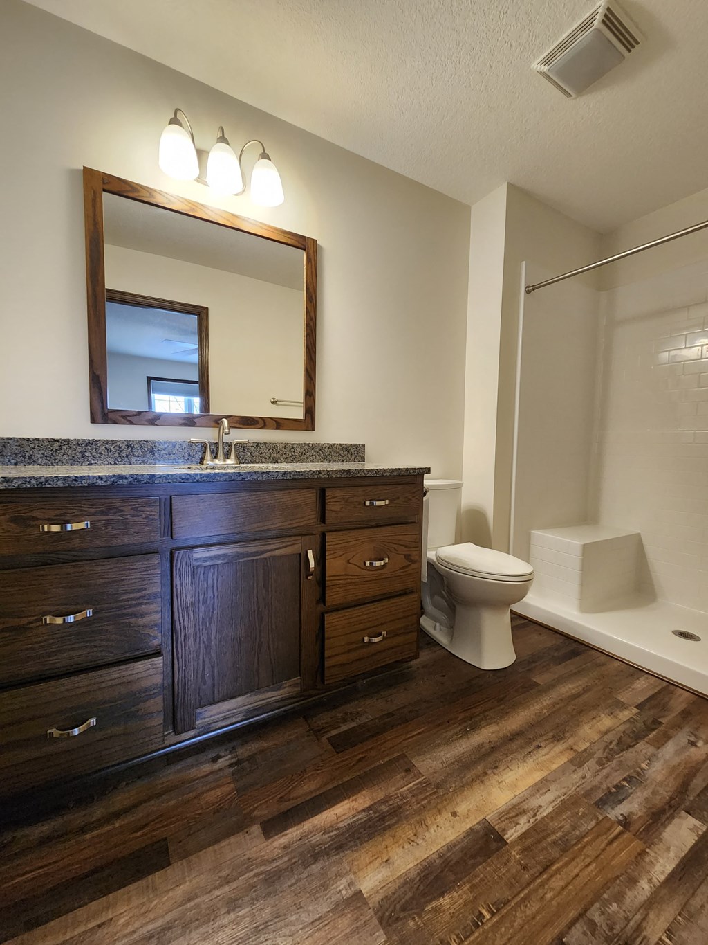 a bathroom with a toilet and a sink and a mirror