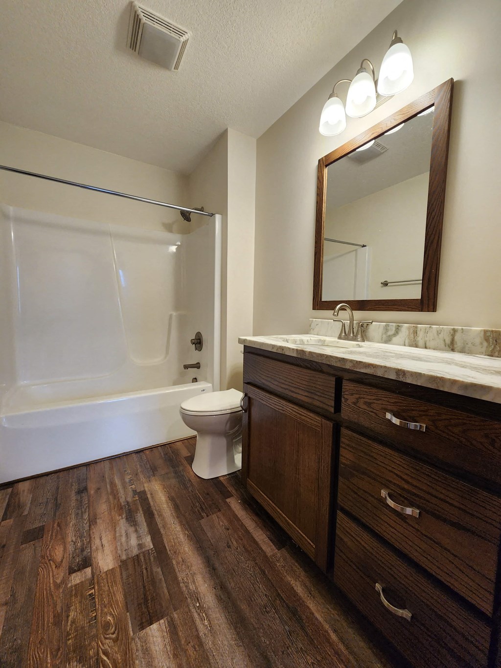 a bathroom with a toilet and a sink and a mirror