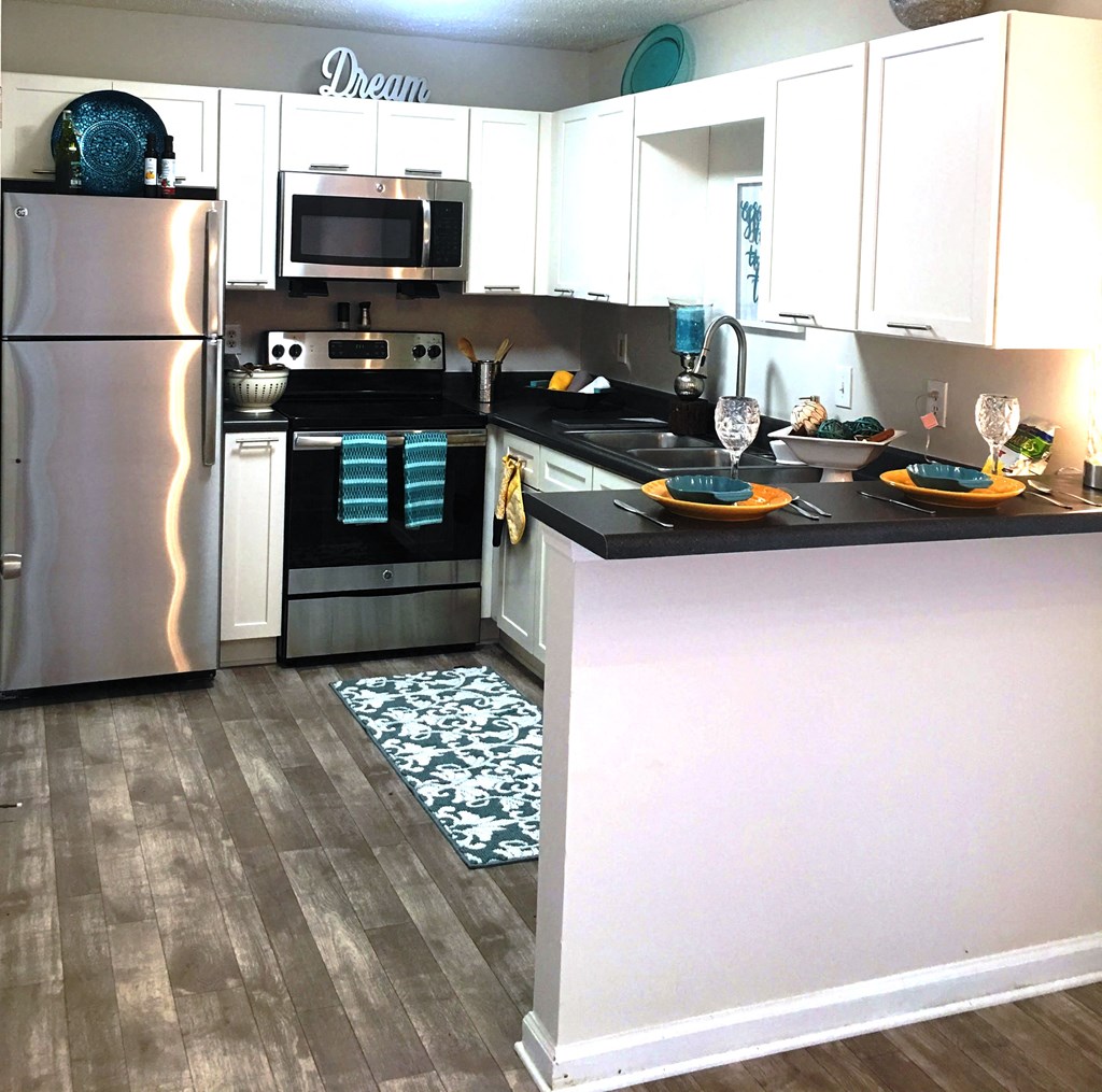 a kitchen with stainless steel appliances and white cabinets