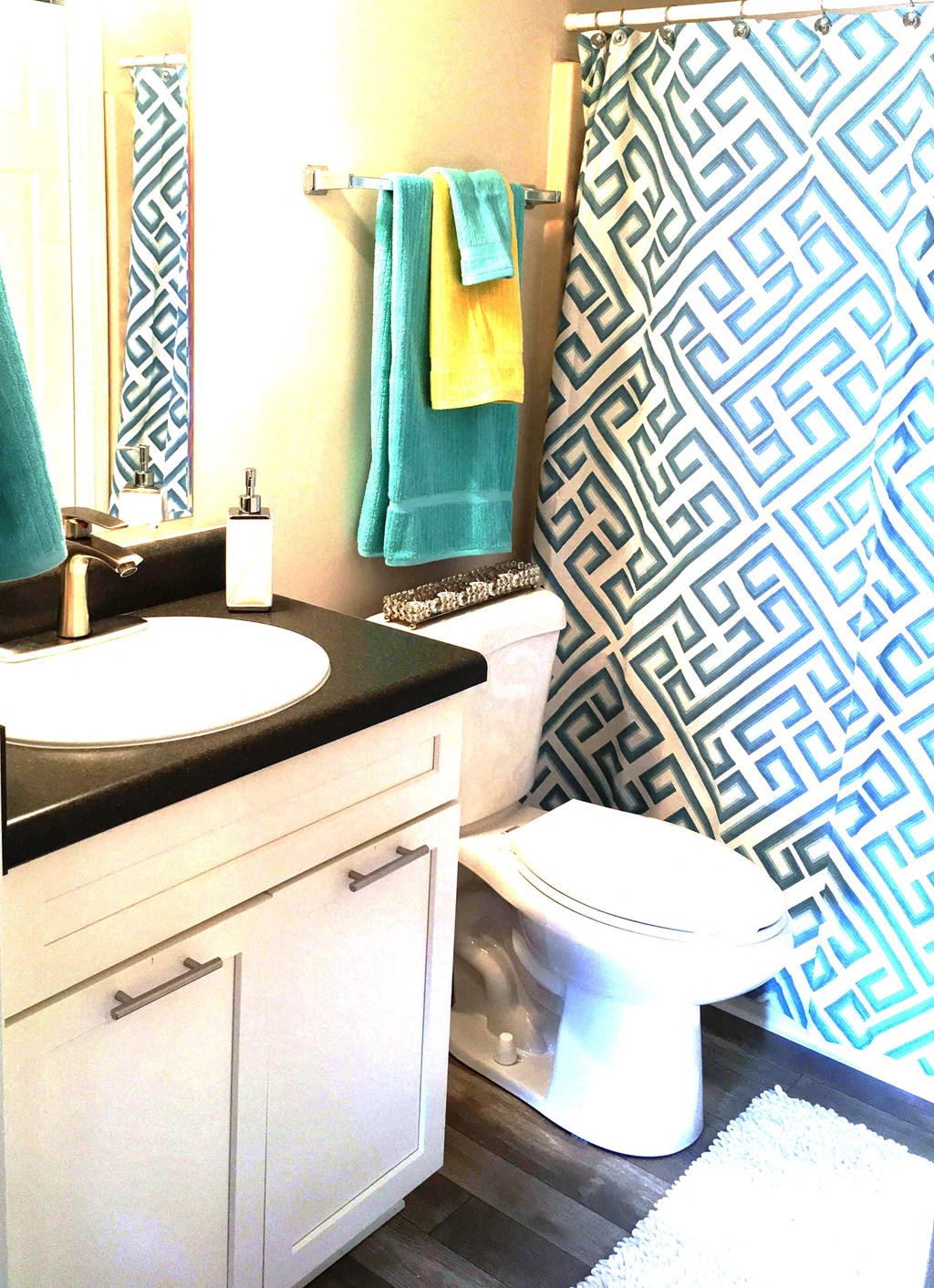 a bathroom with a white toilet and a sink