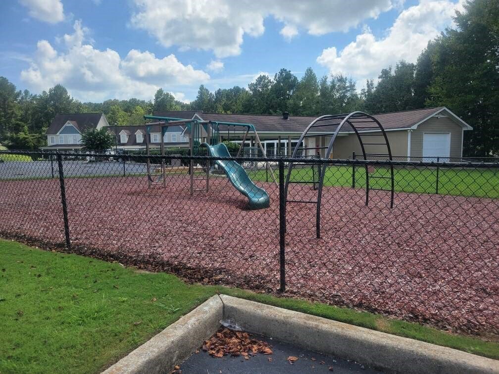 a playground with a slide at a park
