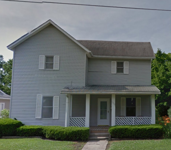 a blue house with white siding and a porch