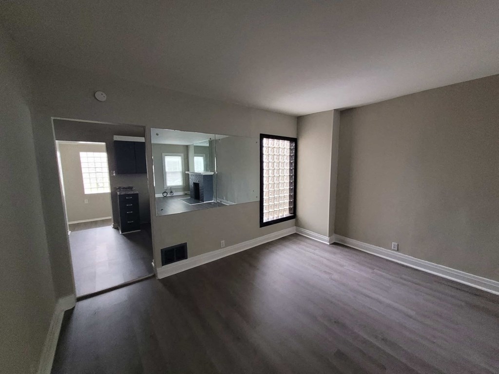 an empty living room and kitchen in a house