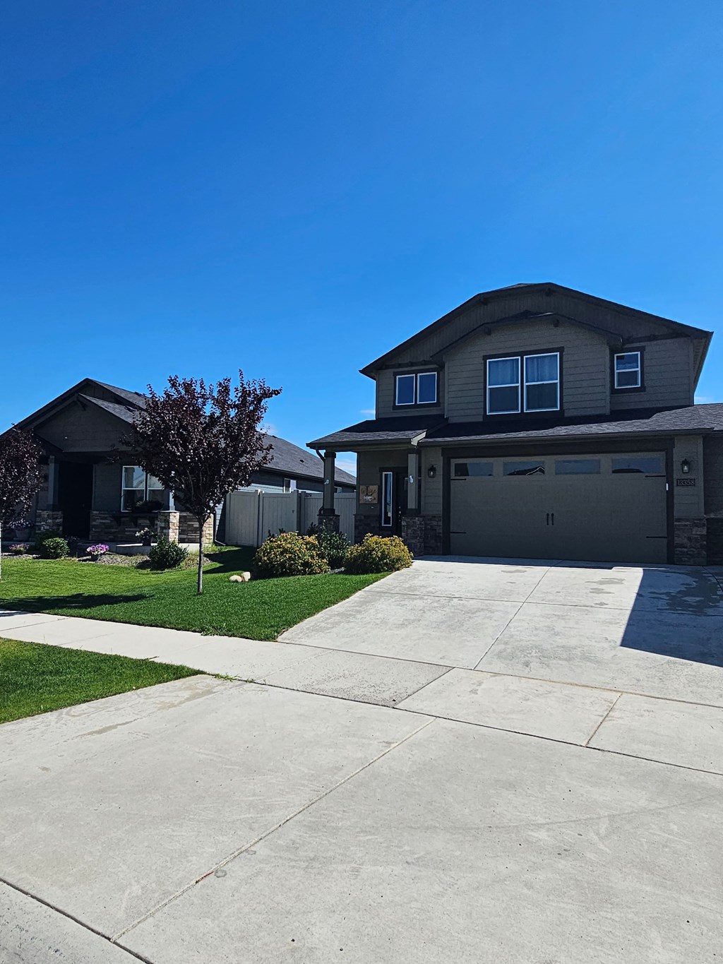 a house with a driveway and a blue sky
