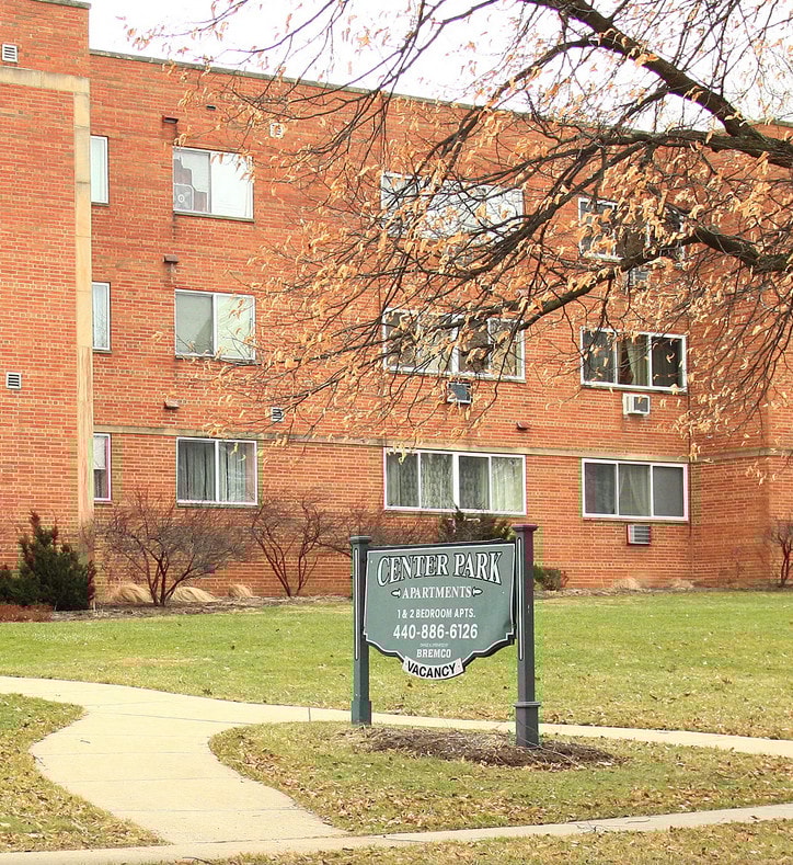 a sign in front of a brick building