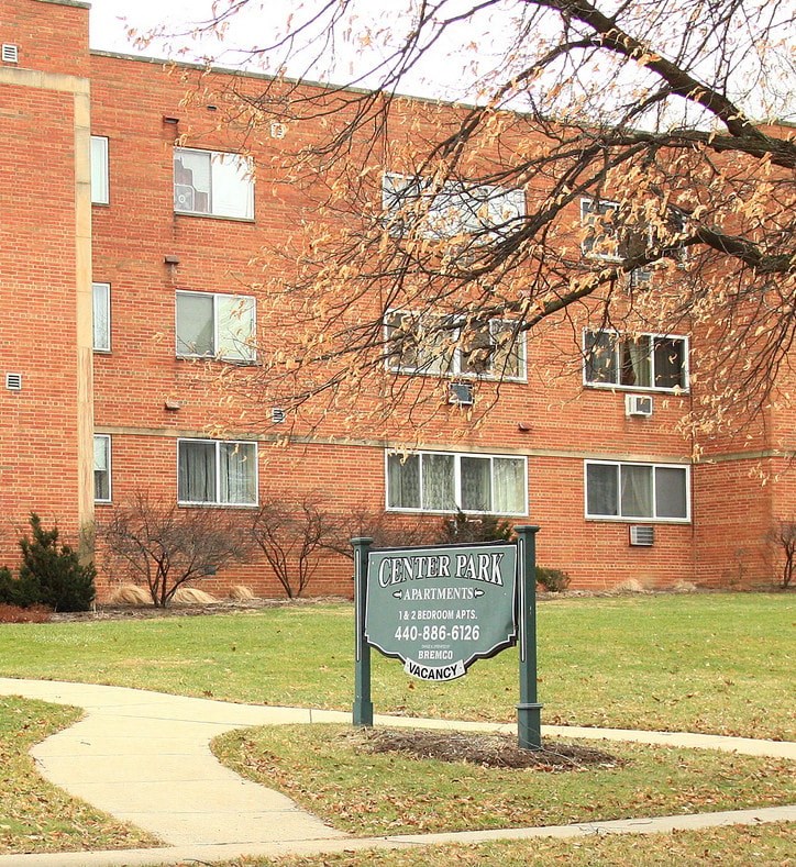 a sign in front of a brick building
